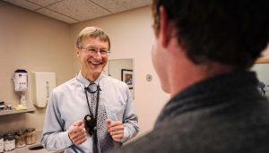 Dr. Gabor Benda with a male patient in an exam room at Bozeman Clinic in Bozeman, MT