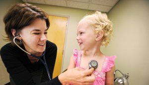 Dr. Christine Mitchell performing a pediatric exam on a patient at Bozeman Clinic