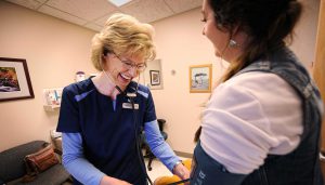 woman's health exam - nurse taking blood pressure at Bozeman Clinic