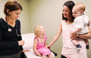 Dr. Christine Mitchell with a family in an exam room at Bozeman Clinic in Bozeman, MT