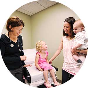 Dr. Christine Mitchell with a family in an exam room at Bozeman Clinic in Bozeman, MT