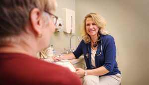 Dr. Heather Wheeler with a patient in an exam room in Bozeman Clinic in Bozeman, MT