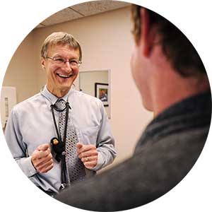 Dr. Gabor Benda with a male patient in an exam room at Bozeman Clinic in Bozeman, MT