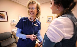 woman's health exam - nurse taking blood pressure at Bozeman Clinic