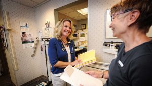 Dr. Wheeler having a conversation with a nurse in the hallway at The Bozeman Clinic